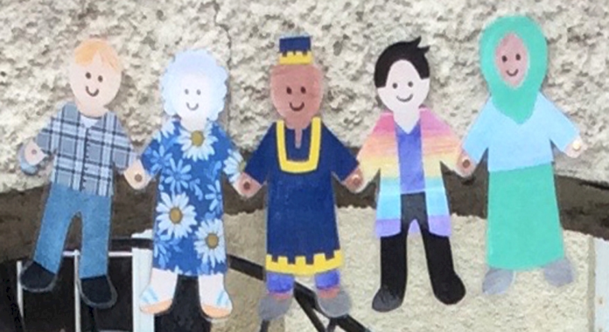 paper cut out fugures of people with different sorts of clothing and skin colour, holding hands